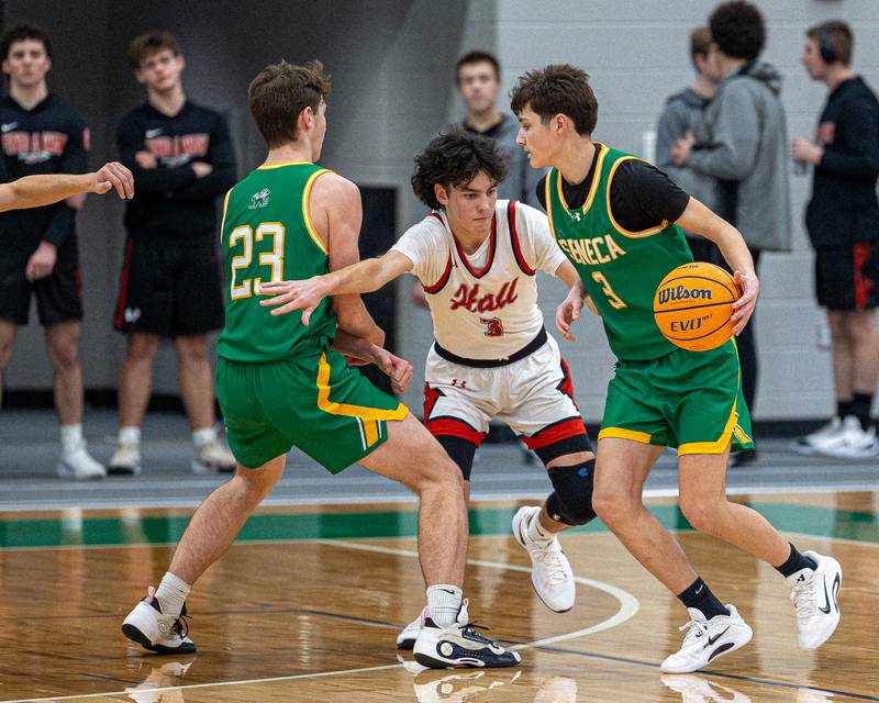 James Zydron (3) of Seneca dribbles ball using screen from teammate Brady Sheedy (23) whilst Noah Plym (3) of Hall tries to jump screen during game in the Shipyard Showdown on Tuesday, December 23, 2025 at Seneca High School in Seneca.