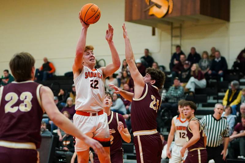 Sandwich’s Dom Rome (22) shoots the ball in the post over Morris’ Ximi Baftiri (21) during a basketball game at Sandwich High School earlier this season.