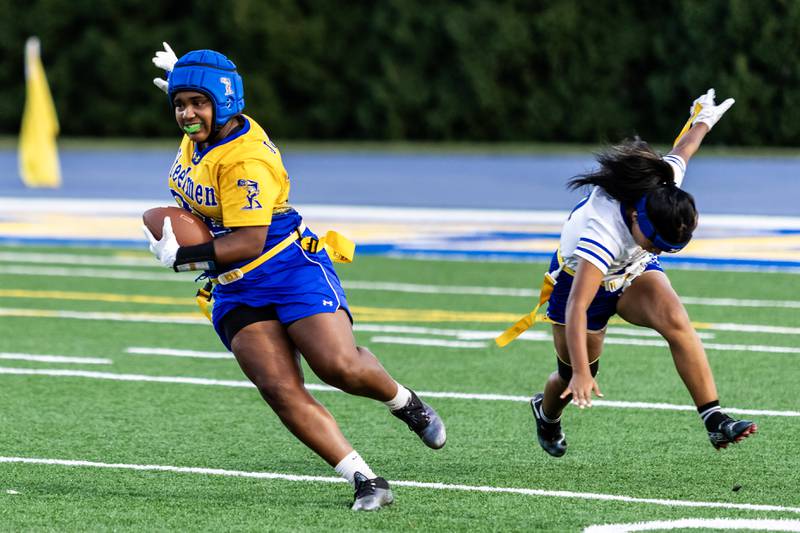 Joliet Central's Georgiana Majerus runs the ball during a varsity flag football home game against Bloom on Sept. 11, 2025.