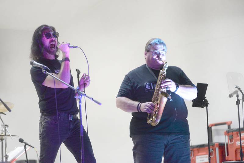 Jeff Anthony sings as John Carlson plays the saxophone with Brass From The Past at the Jamboree Concert Series on Friday, Aug. 1, 2025 in Mt. Morris.