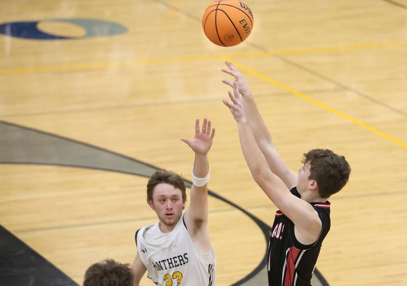 Henry-Senachwine's Landon Harbison sinks a three over Putnam County's Braden Bickerman on Friday, Dec. 5, 2025 at Putnam County High School.