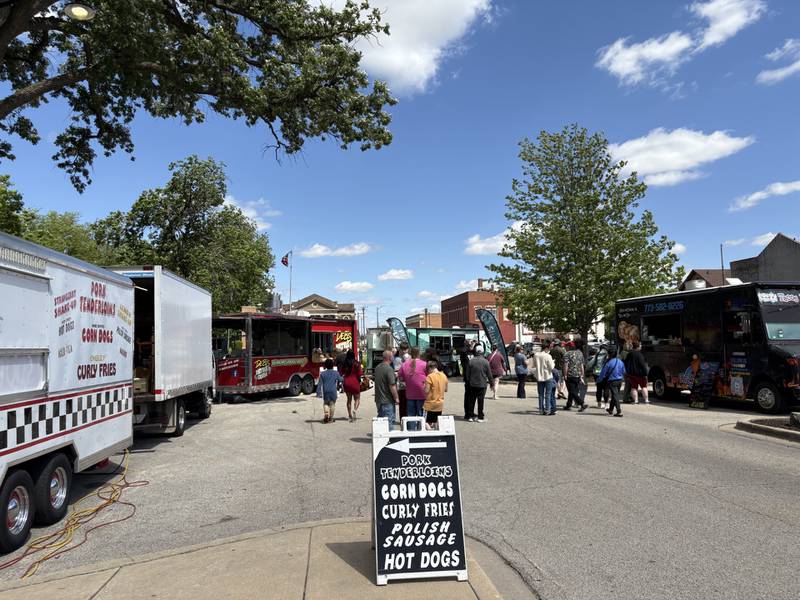 Visitors browse food trucks during the Streator Food Truck Festival on Saturday, May 17 at City Park.