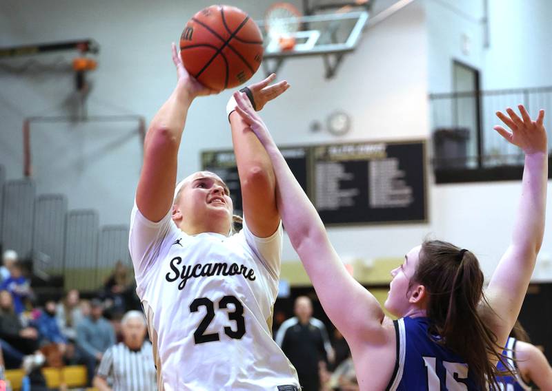 Sycamore's Evyn Carrier shoots over Geneva's Cassidy Arni during their game Monday, Nov. 14, 2022, at Sycamore High School.