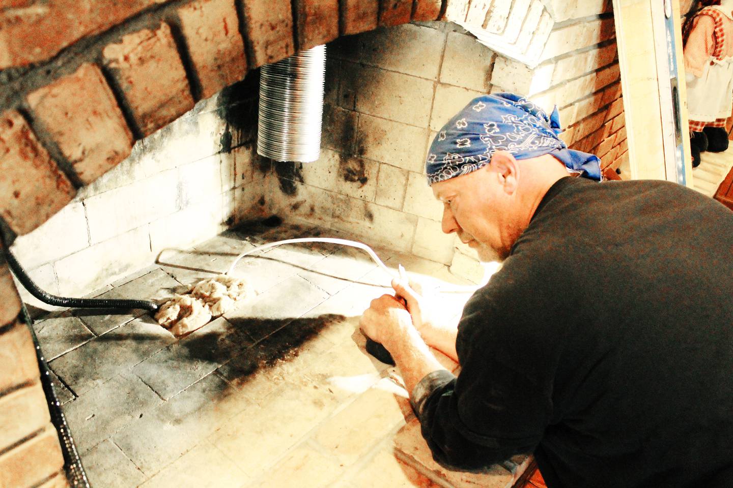 Jason Nesemeier of Loescher Heating and Air Conditioning in Freeport installs a gas fireplace at a Freeport home.