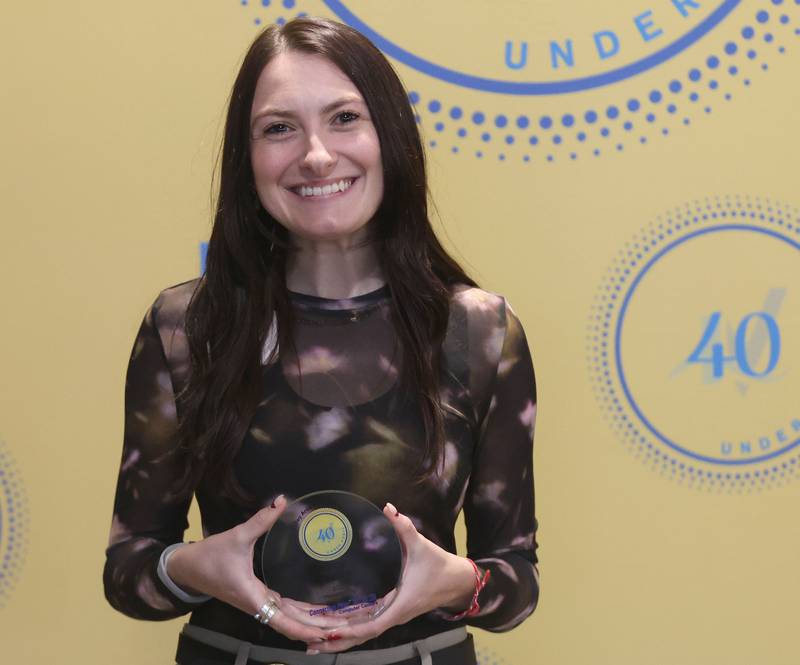 Paige Scoma poses with her 40 Under Forty award during the Illinois Valley Chamber of Commerce Champions of Change Awards Night on Wednesday, May 6, 2026 at the Westclox Event Center in Peru.