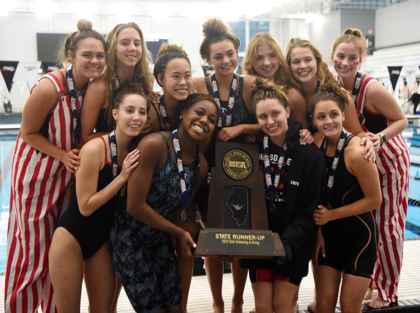 Hinsdale Central swimmers hold their second-place trophy during the IHSA girls state swimming finals at FMC Natatorium in Westmont on Saturday, Nov. 12, 2022.