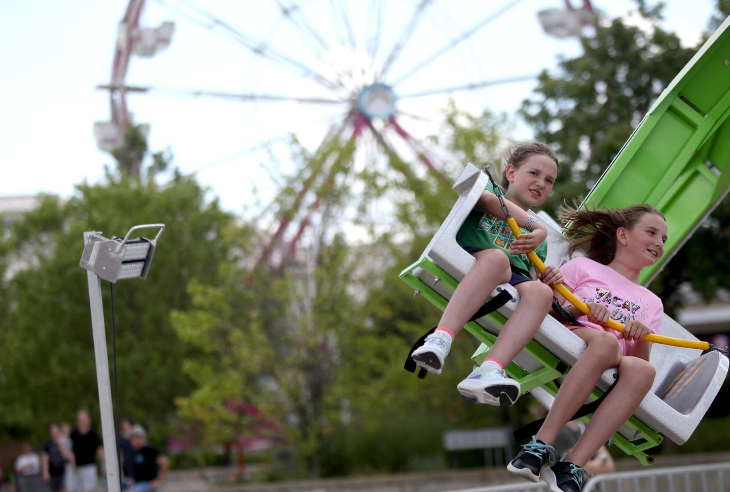 Sisters Norah, 8, and Abigail Epich, 11, of Pingree Grove try out one of the rides during opening day at the Kane County Fair on Wednesday, July 13, 2022.