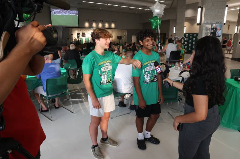 Providence students JT Potocsnak, left, and Jovanny Gonzalez do a tv interview at the Providence Catholic Brad Guzan watch party on Tuesday, July 25 in New Lenox. Guzan is a Providence Catholic alumnus who plays goalie for MLS’ Atlanta United FC.