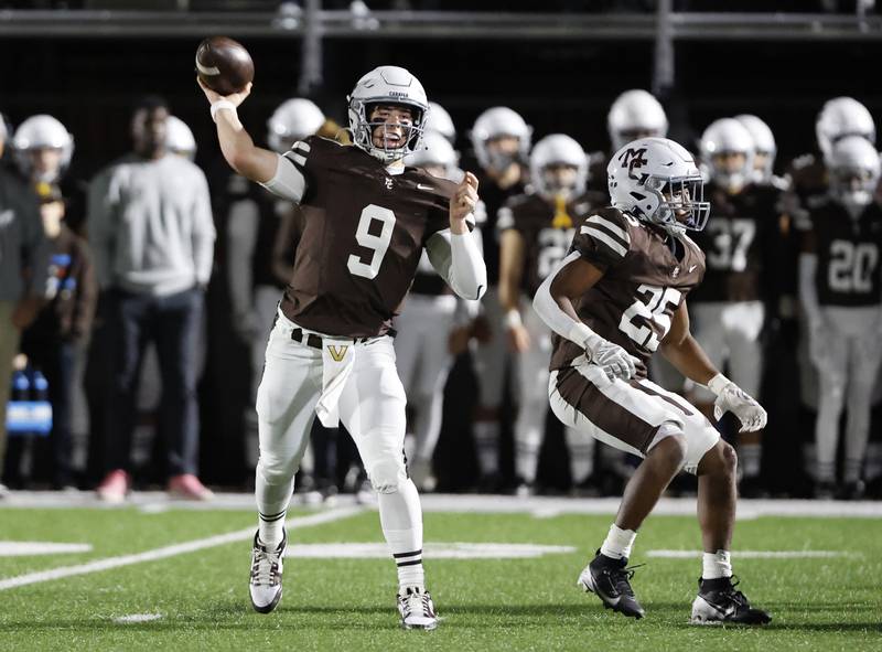 Mt. Carmel's Jack Elliott (9) passes during the varsity football game between Loyola Academy and Mt. Carmel high school on Friday, Oct. 25, 2024 in Chicago.
