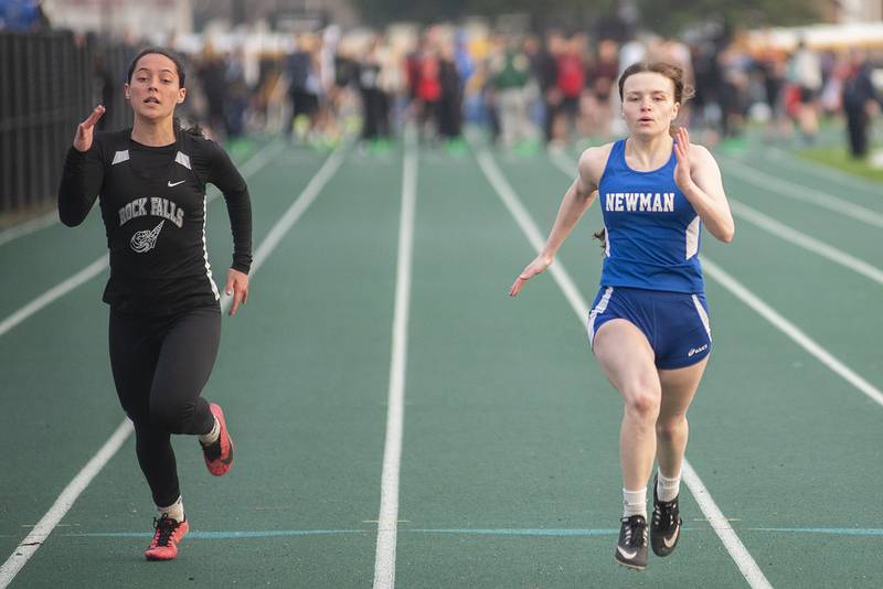 Rock Falls' Carli Kobbeman (left) and Newman's Syrinidie Fowkes race for the finish in the 100 dash Friday, April 22, 2022 at the Rock Falls track invitational.