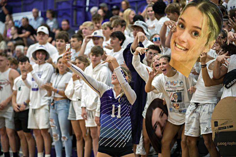 Dixon’s Ella Govig snaps a selfie with her classmates before the volleyball game against Sterling Tuesday, Aug. 23, 2022.