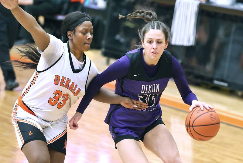 Dixon’s Harvest Day tries to drive around DeKalb's Cayla Evans during their game Monday, Jan. 23, 2023, at DeKalb High School.