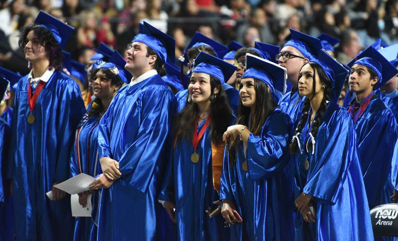 Dundee-Crown High School seniors look for fellow graduates on the big screen during the graduation ceremony on Saturday, May 21 at the Now Arena in Hoffman Estates.