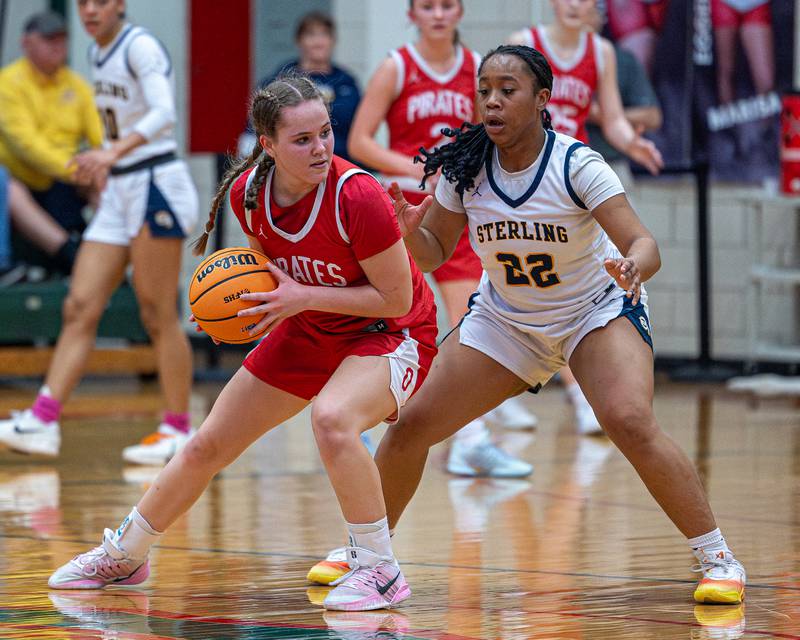 Ottawa's Hailey Thrush (21) holds ball as Joslyn Green (22) of Sterling defends during Regional Championship game on Thursday, Feb. 19, 2026 in Sellett Gymnasium at L-P High School.