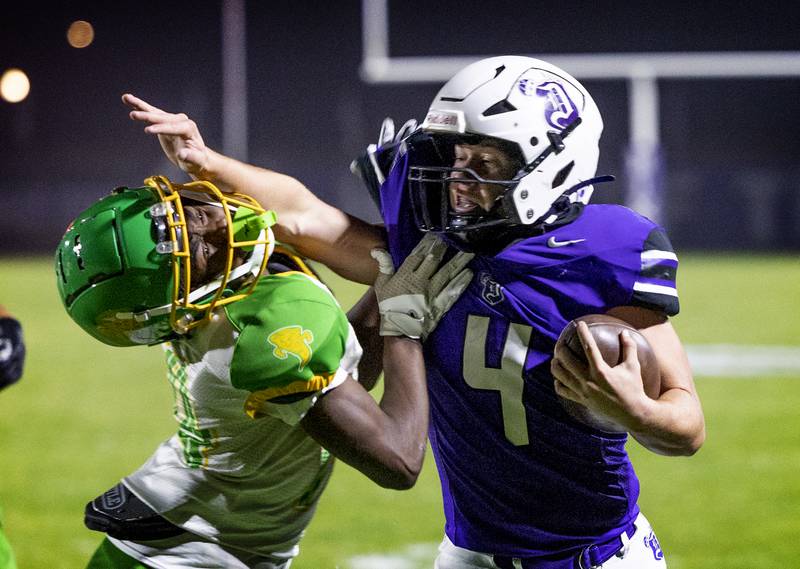 Dixon’s Landon Knigge fights in the end zone against Chicago Ag Science’s Alex Calhoun Friday, Nov. 8, 2024 in the second round of the Class 4A football playoffs.