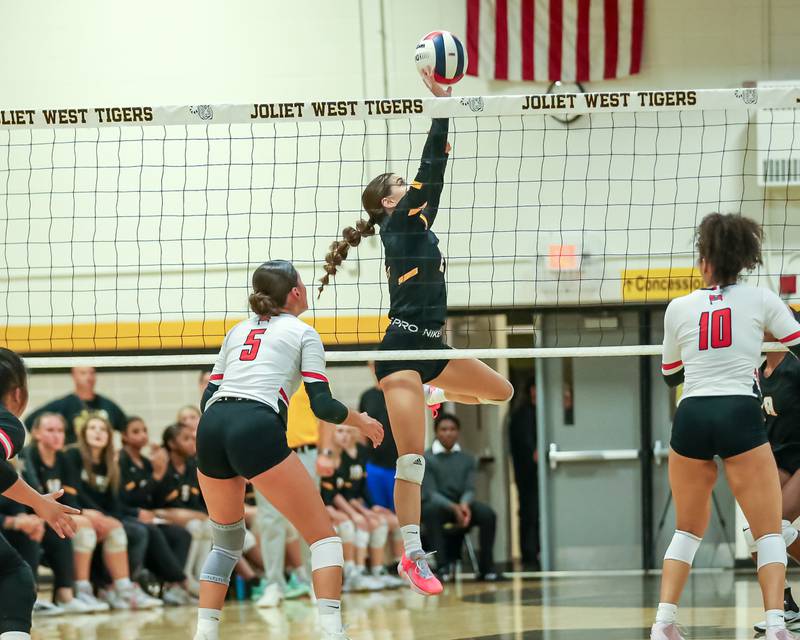 Joliet West's Natalia Harris (24) sets a shot during regional final volleyball match between Bolingbrook at Joliet West.  Oct 26, 2023.