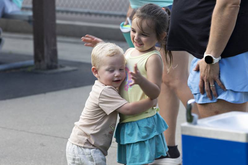 Clayton Kemmerer, 1, gives cousin Chloe Kemmerer, 3, a hug Friday, July 25, 2025, during a family fun day at the end of the Emma Hubbs Tennis Classic in Dixon.