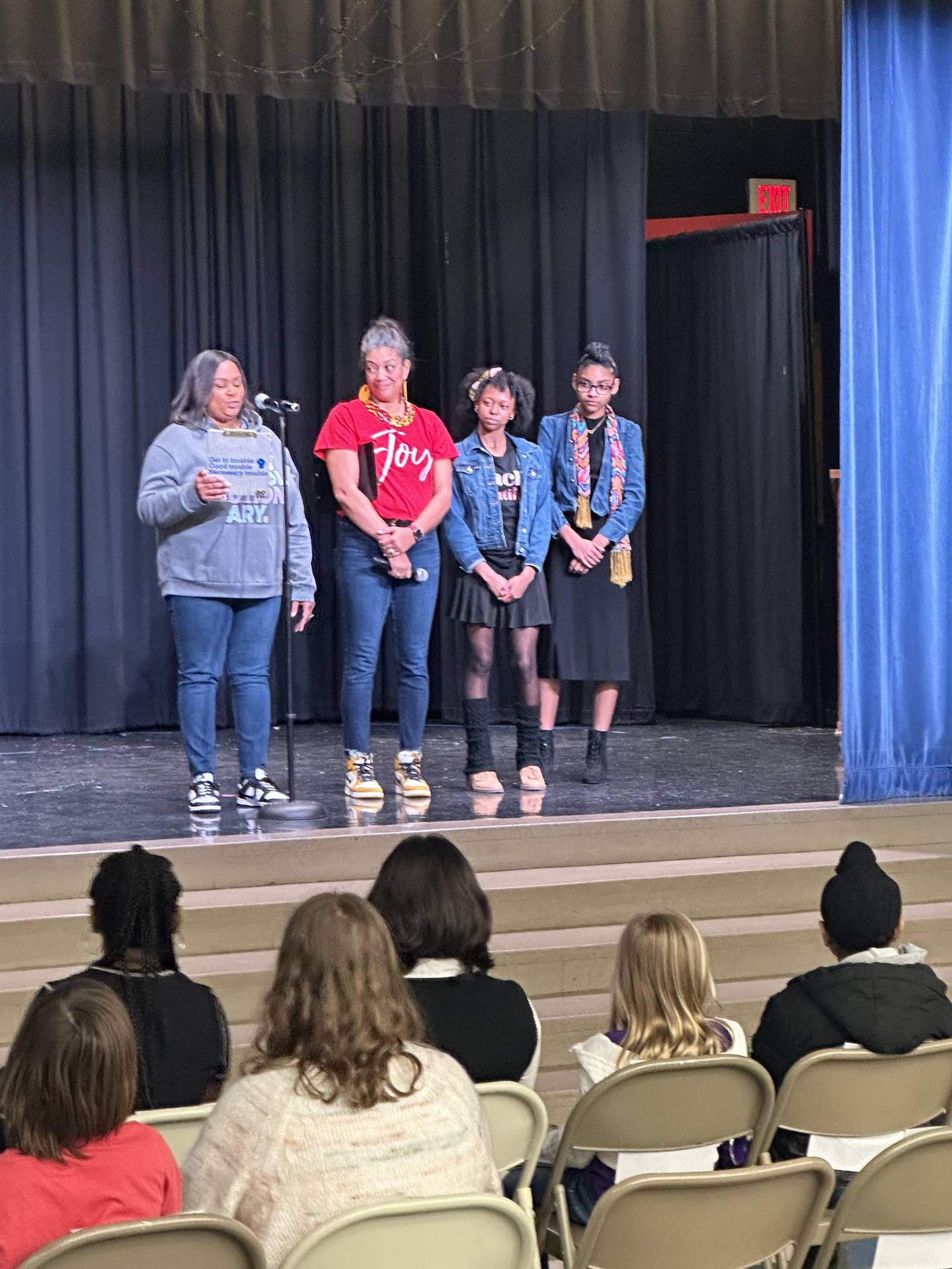 AAPAC President Qiana Monroe thanks everyone for attending and introducing emcee Nikki Rung; Jr. emcee Caelyn McDaniel, eighth grade; and Jr. emcee Samiya McBean, eighth grade, during the "Drop the Mic" event at Big Hollow School in Ingleside.