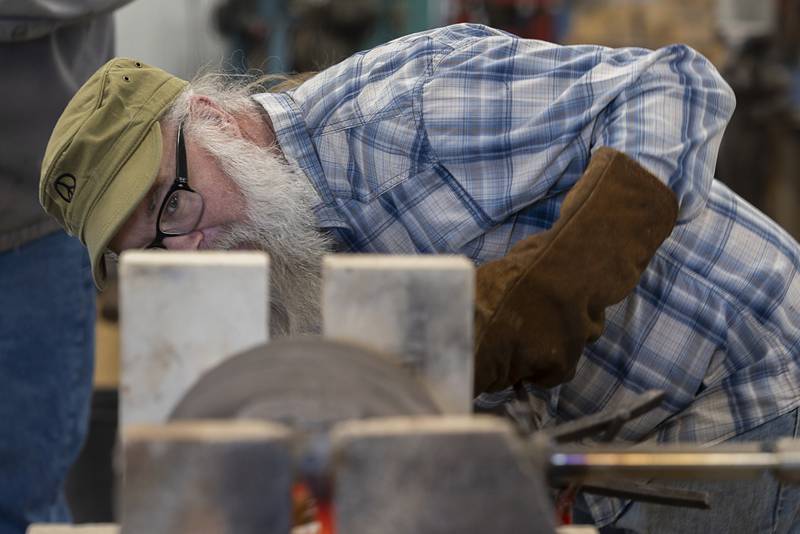 Mark Stach learned that heating the metal and hammering it flat has kept the pieces from snapping and breaking.