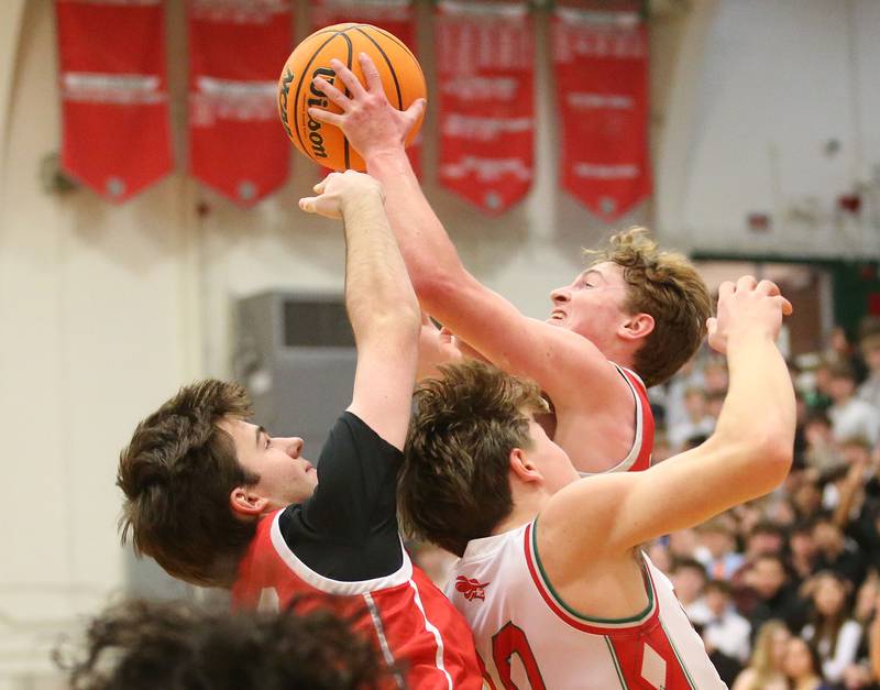 Ottawa's Evan Snook and teammate Seth Cooper grab a rebound over L-P's Braylin Bond on Friday, Feb. 7, 2025 in Sellett Gymnasium at L-P High School.