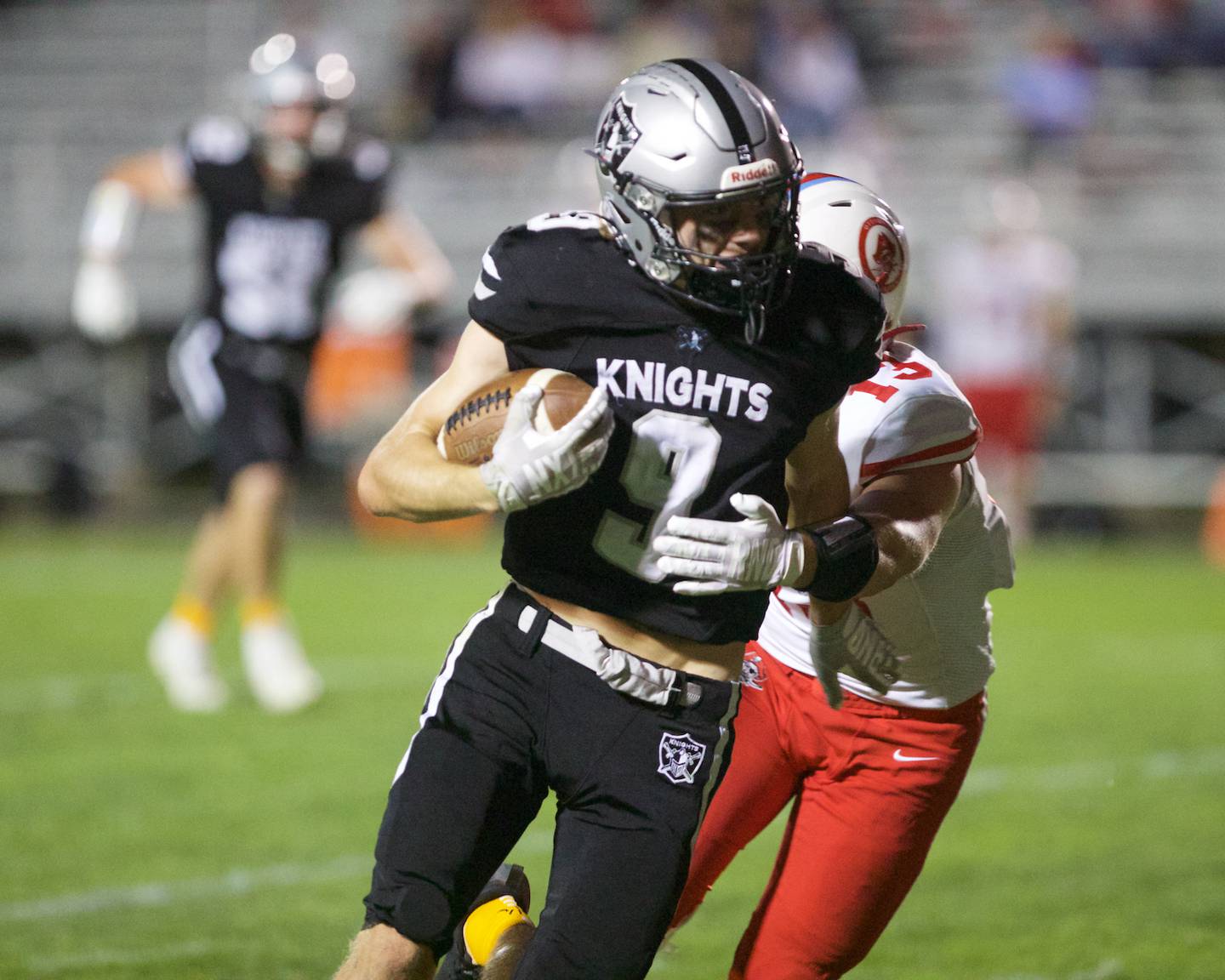 Kaneland's Carter Grabowski runs the ball against Ottawa 's Ethan Poutre on Friday, Sept. 19, 2025 in Maple Park.