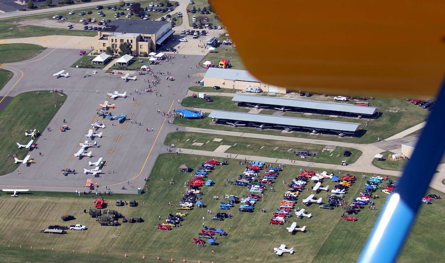 Aerial view of Joliet Airport Fest 2014 as seen Sunday from the cockpit of Keith Birsa's Boeing Stearman. Jenny McFarland, Joliet Park District Airport Superintendent was pleased with the weather and noted that this year's event attracted the largest crowd since the event's inception 10 years ago.
