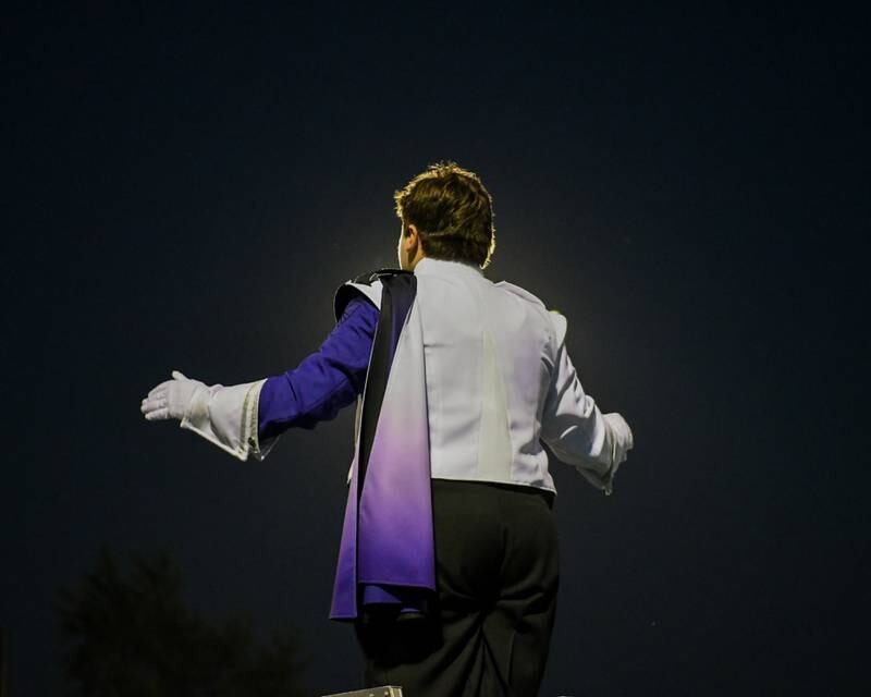 Downers Grove North drum major Charlie Janka conducts during the Downers Grove South Marching Mustangs Music Bowl on Saturday Oct. 5, 2024, held at Downers Grove South.