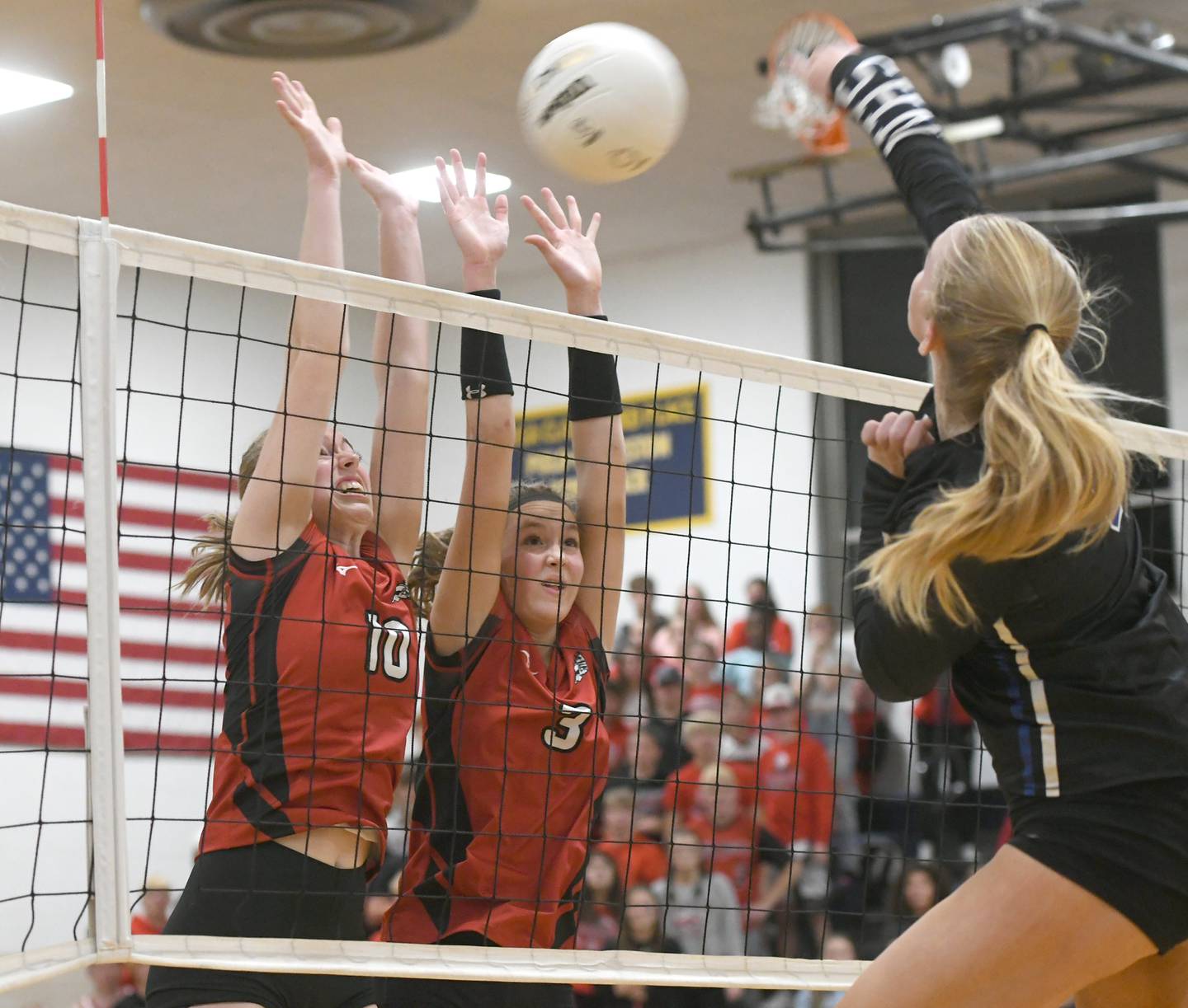 A spike by Newman's Jess Johns sails over Fulton's Reese Dykstra (10) and Annaka Hackett in the third set at the 1A Polo Regional on Thursday, Oct. 27, 2022.