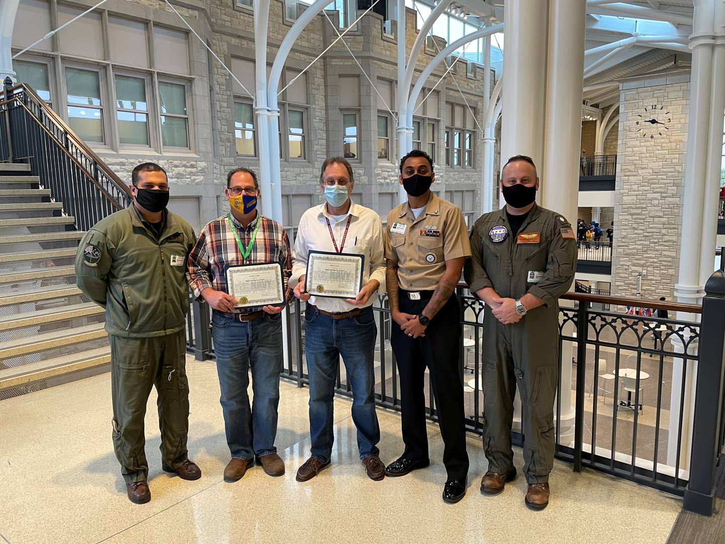 The Navy recognized Milton George and Tim Gyrgiel, teachers in Joliet Central’s Career and technical education (CTE) department, with its Navy Impact Influencer Award. Pictured are CDR Matthew Roy, Joliet Central CTE teacher Tim Gyrgiel, Joliet Central CTE teacher Milton George, Petty Officer Beyer and CDR Matthew Sass.