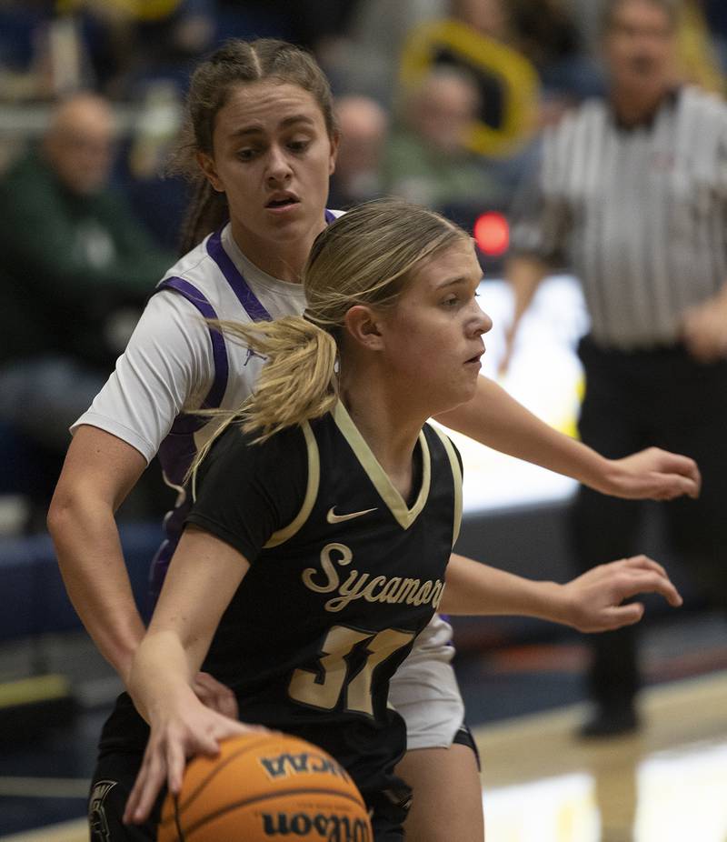 Plano’s Josie Larson reaches for the ball against Sycamore’s Quinn Carrier Monday, Feb. 17, 2025, during a 3A semifinal in Sterling.