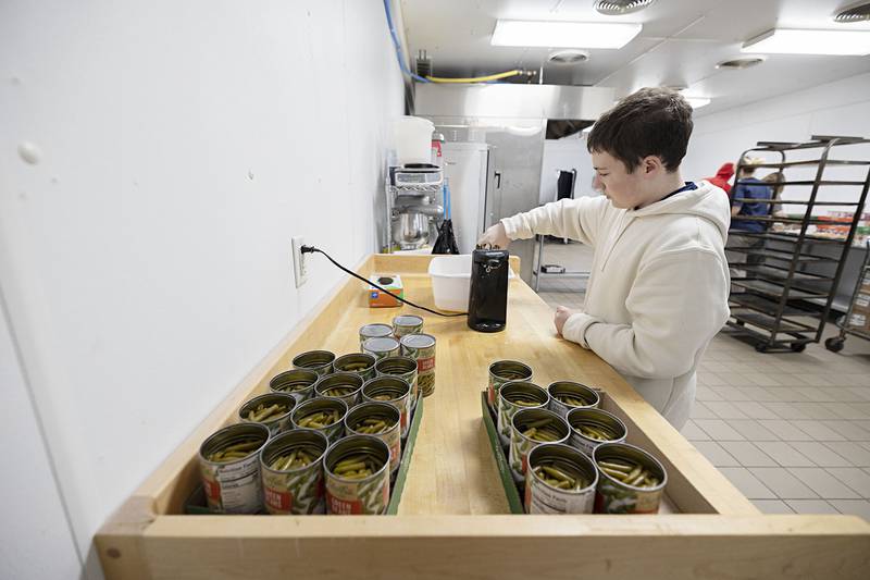 Parker Fogel of Dixon High School helps with food prep Wednesday, Nov. 26, 2025, while volunteering as part of SVCC’s Impact program. A group of students prepared meals through the Path to the Future program organized through the Regional Office of Education.