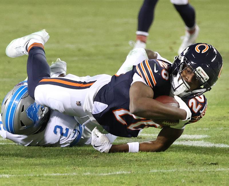 Chicago Bears wide receiver Jahdae Walker dives over Detroit Lions safety Daniel Thomas for extra yardage during their game Sunday, Jan. 4, 2026, at Soldier Field in Chicago.