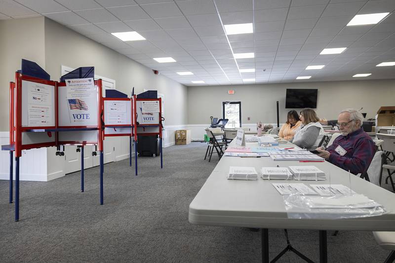 Election judges pass the time between voters Tuesday, March 17, 2026, at Harvest Time Church in Rock Falls. The judges saw slow voter turnout for this March primary.