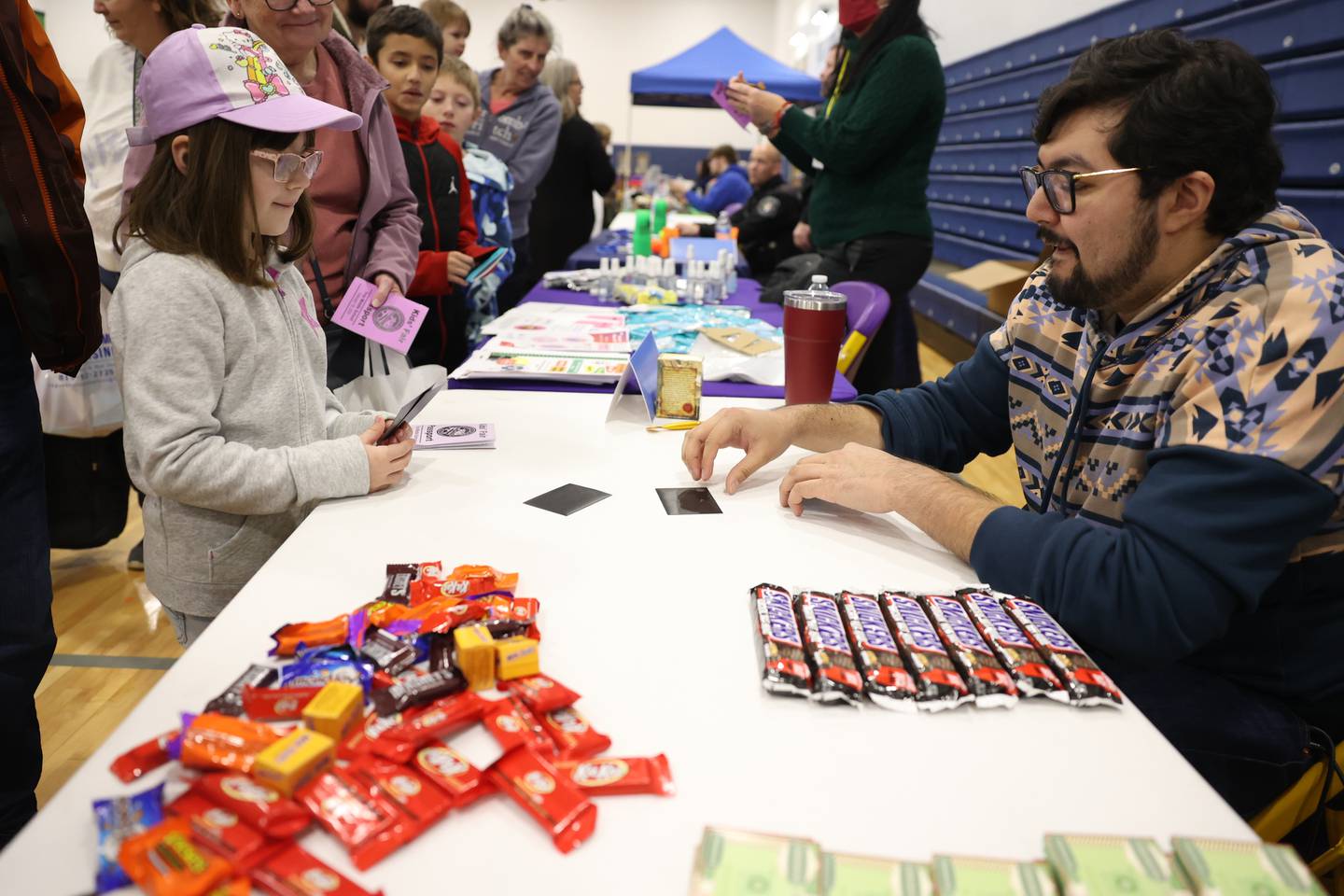 Dana, 9, plays a card game with Andrea Su at the Holsten Human Capital Capital Development vendor at the Will County Executive 2024 Kids’ Fair at Troy Middle School in Plainfield on Monday, Feb. 19, 2024.