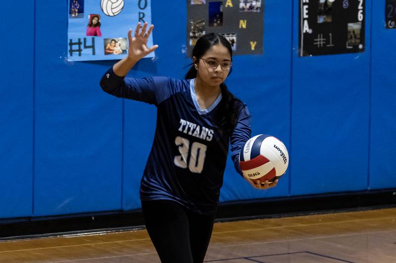 Illinois Mathematics & Science Academy's Fiza Shaikh serves during a varsity volleyball game against Joliet Central at Joliet Central on Oct. 20, 2025.