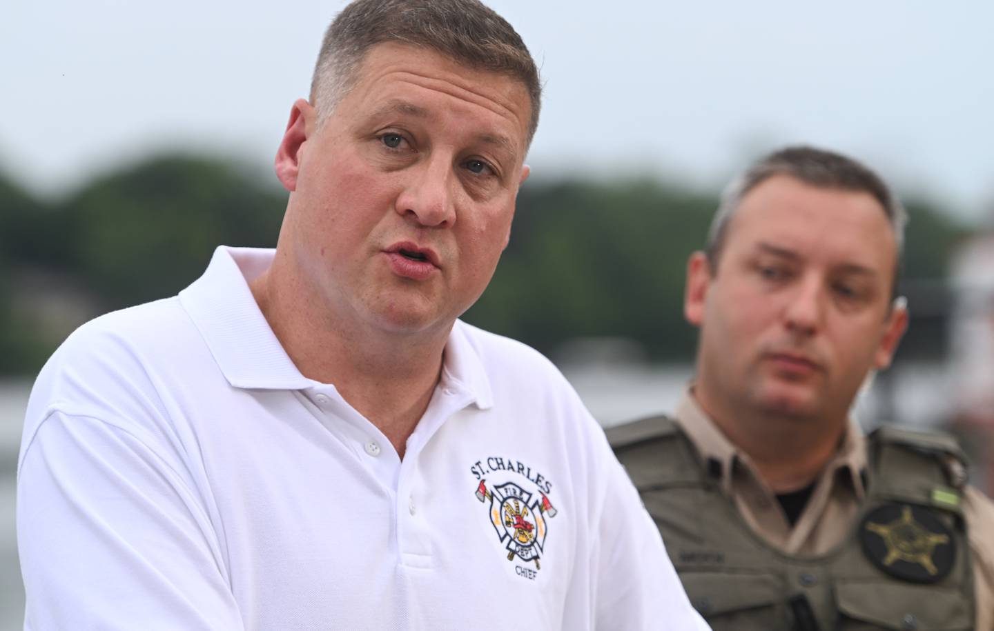 St. Charles fire chief Jeremy Mauthe, left, and Illinois Dept. of Natural Resources area commander Josh Mooi talk about the recovery efforts Wednesday morning for a missing Fox River kayaker in St. Charles.