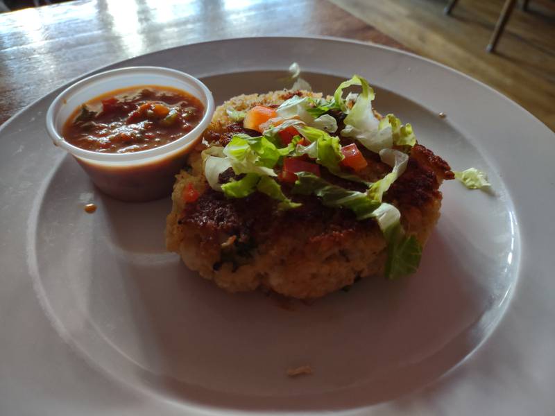 The jumbo lump crab cake at Canal Port in Utica is blue shell crab cake served with savory roasted red pepper sauce, and the sauce is fabulous.