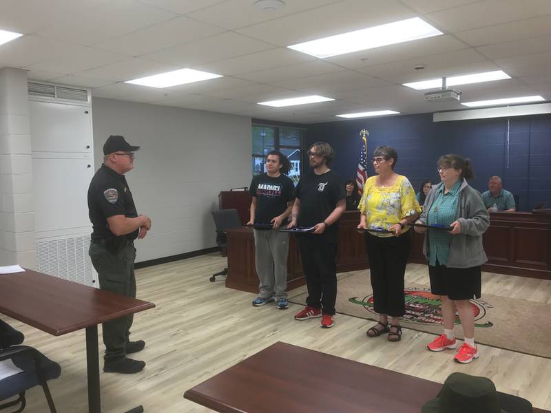 Utica Police Chief Rod Damron (from left) congratulates Damien Kwit, Austin Craig, Victoria Cantrell and Lisa Piechafor the critical aid they rendered during an April 10 rollover accident on Dee Bennett Road, a half mile east of Route 178.