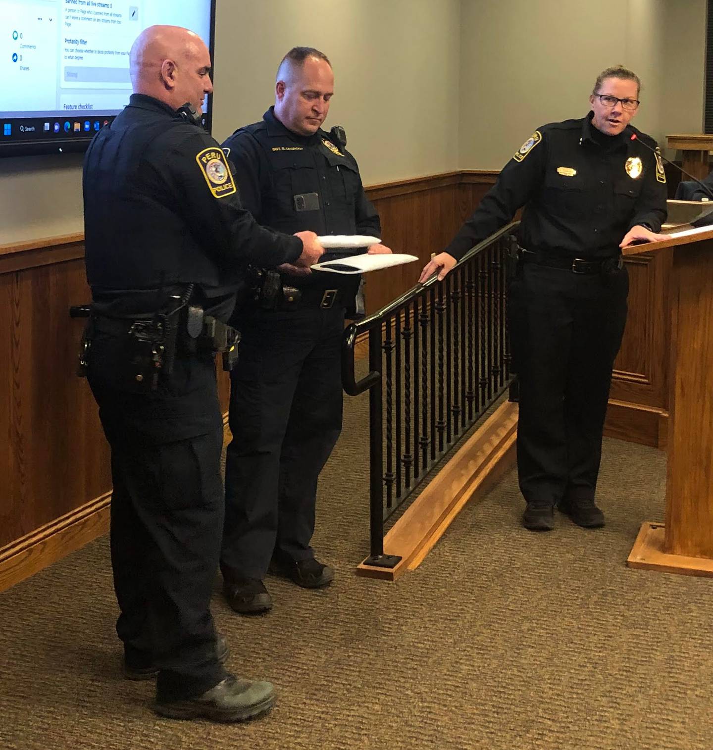 Peru police officer Brad Jones (left) is given a lifesaving award for his actions in saving a woman's life on Monday, Feb 13, 2023 during the Peru Council meeting .