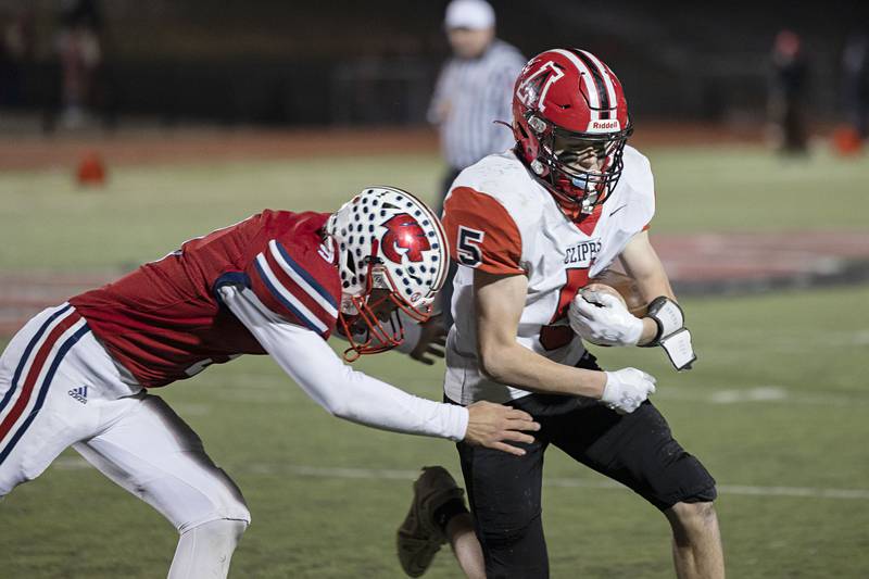 Amboy’s Landon Whelchel is hauled down after a gain Friday, Nov. 18, 2022 in the 8-man championship football game against West Central.