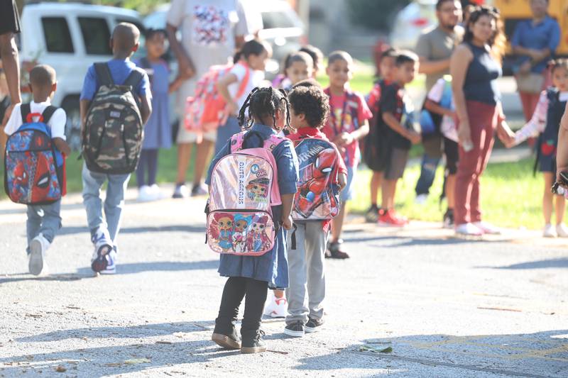 Students start to arrive for the first day of school at Woodland Elementary School in Joliet. Wednesday, Aug. 17, 2022, in Joliet.