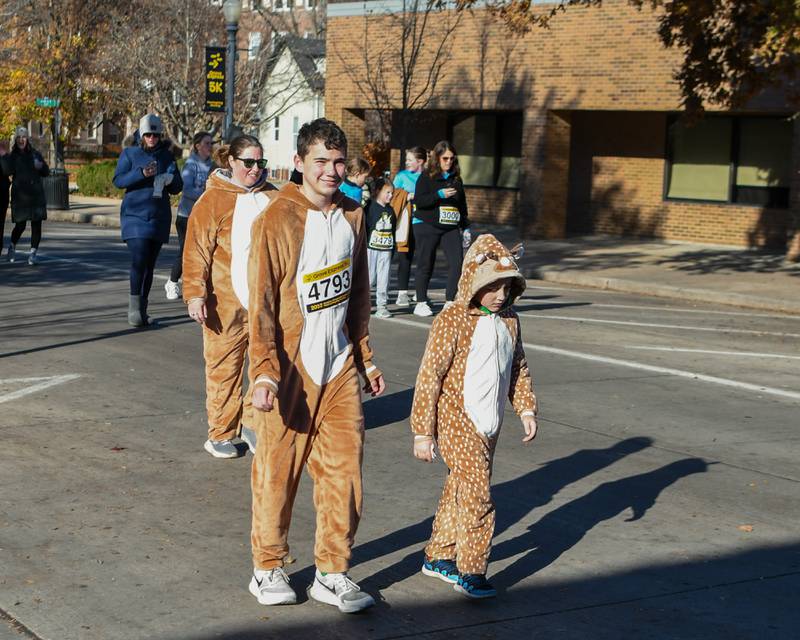 Owen Nachman, 13, Barrett Nachman, 8, and their mom Rebecca Nachman, who all dressed as deers took part in the Grove Express 5k race held on Thursday Nov. 23, 2023, in Downtown Downers Grove.