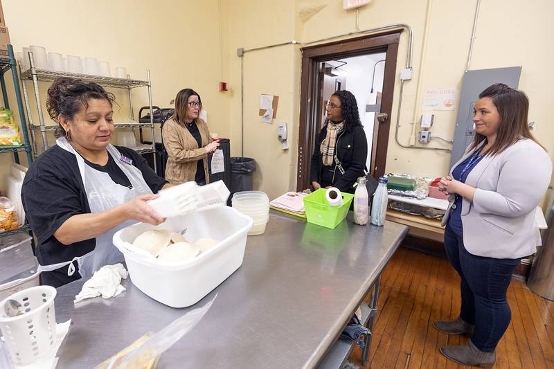 Kitchen staff member Melissa Anspach (left) works while TCOC Early Head Start/Head Start program director Rachael DeSpain, Connie Marney, District Director for Tony McCombie and Wallace School acting director Amber Stavenger chat in the kitchen Thursday, Jan. 23, 2025, at Wallace School in Sterling.