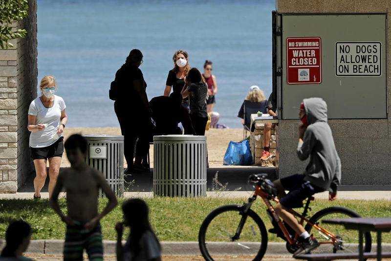 Signs are seen June 23 at Clark Street Beach during COVID-19 as people gather in Evanston.