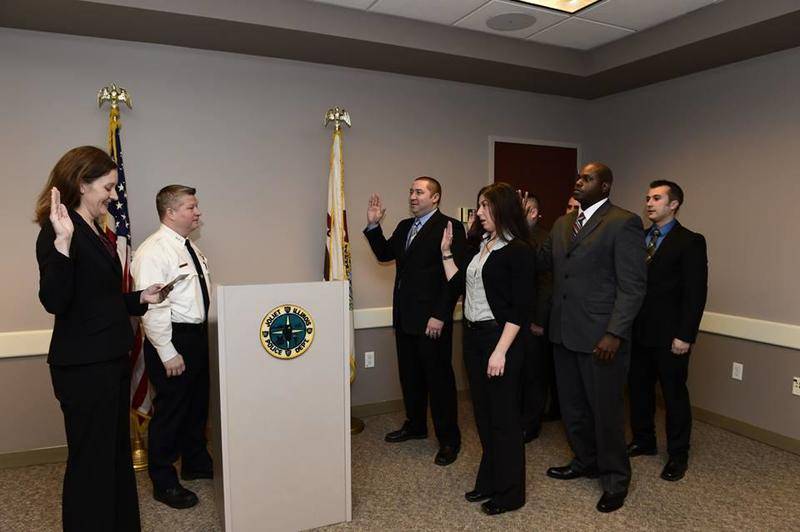 Joliet Police Officer Cassandra Socha, center, was sworn in to the department in 2014. Socha is suing the city, a police detective and 20 unidentified police officers. The lawsuit alleges the detective shared with the officers private images of Socha nude or engaged in sex acts.