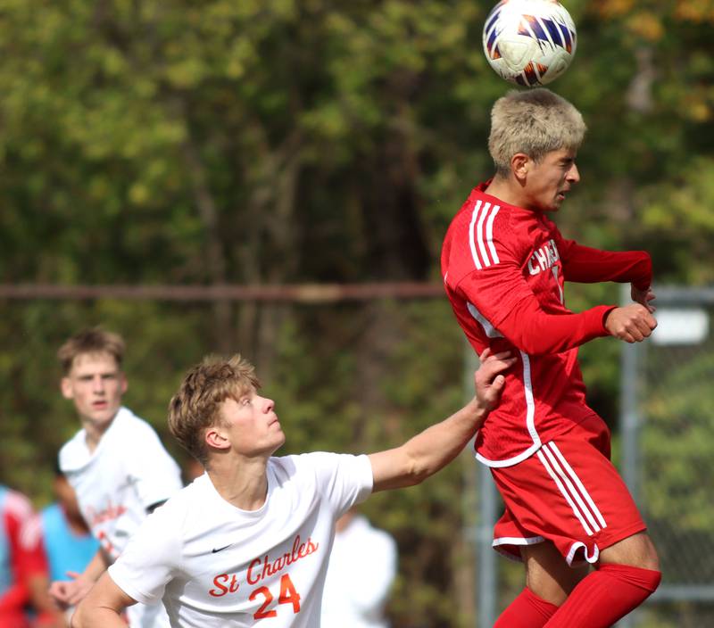 Dundee-Crown’s Hugo Arista, right, gets to the ball ahead of St. Charles East’s Colten Pariso  in IHSA Class 3A Regional Championship soccer at Dundee-Crown High School in Carpentersville on Saturday, October 25, 2025.