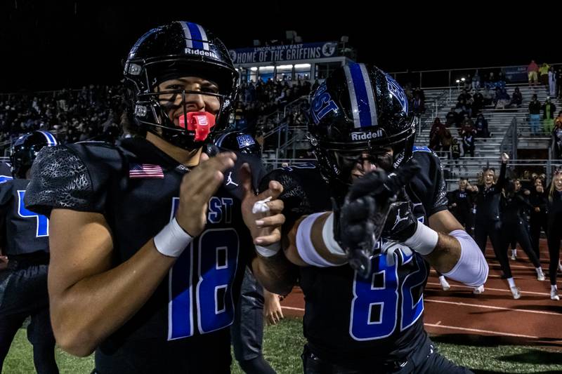 Lincoln-Way East's Edwin Villagomez and Nick Maheras celebrate after their team scores a touchdown during a varsity football round one playoff game against Stevenson at Lincoln-Way East on Oct. 31, 2025.