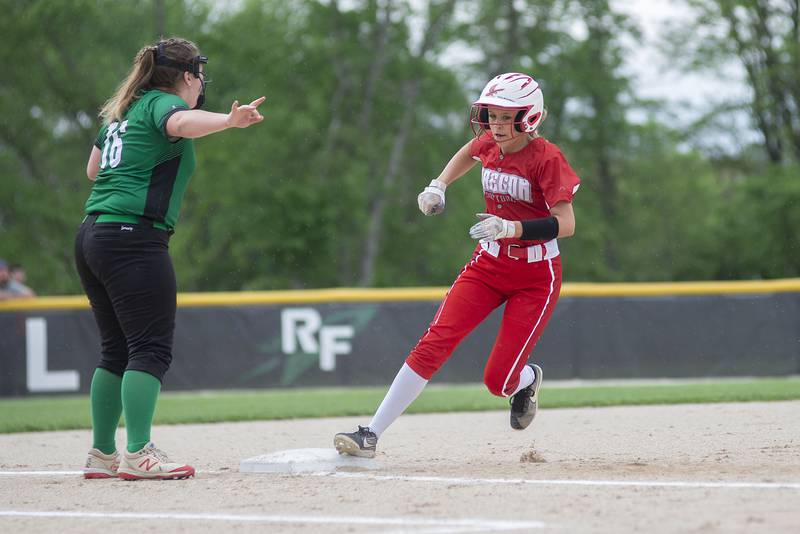 Oregon’s Haleigh Burkhart rounds third to score the first run for the Hawks Friday, May 20, 2022.