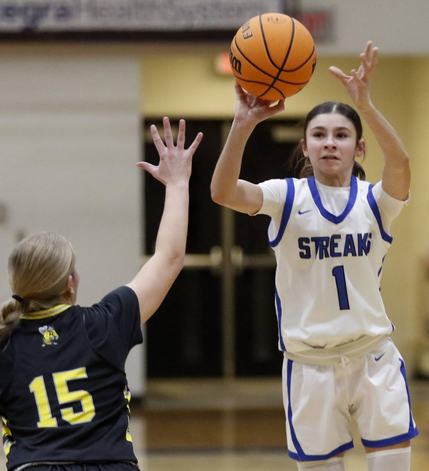 Woodstock's Alex Nowacki shoots th ball over Harvard's Elena Olbrich during a Kishwaukee River Conference girls basketball game on Monday Jan. 12, 2026, at Woodstock High School.