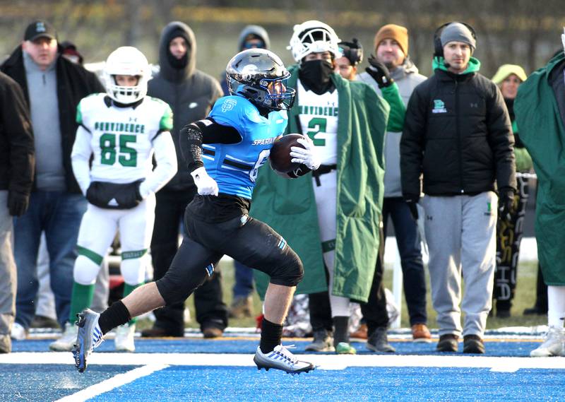 St. Francis’ Brady Piper carries the ball to the end zone during their Class 4A semifinal game against Providence in Wheaton on Friday, Nov. 19. 2022.
